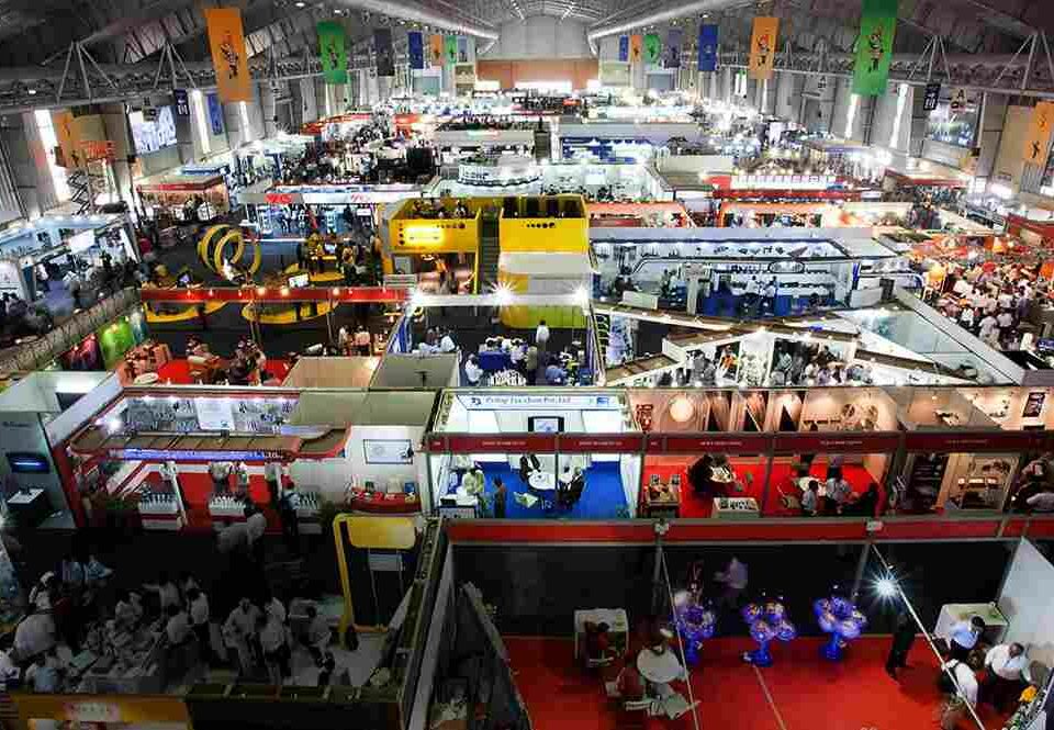 This image shows a trade fair in Delhi with several brands and people in one place