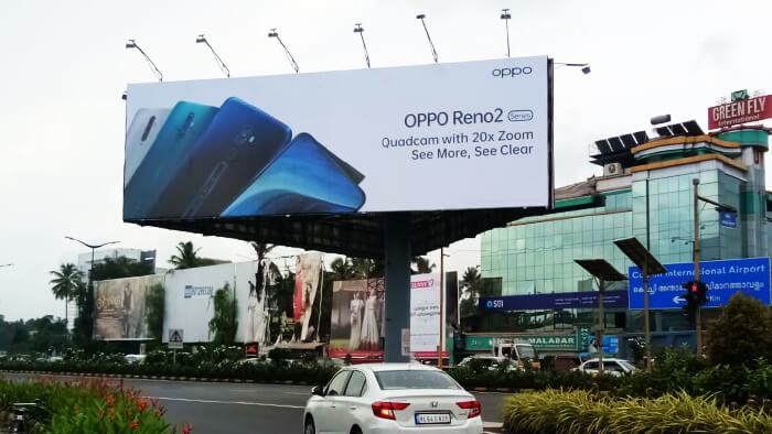 This image shows a basic and simple OOH ad by Oppo on a billboard across a street