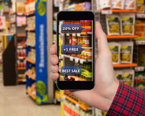 This image shows a man holding a phone in hand and searching for discounts using AR feature