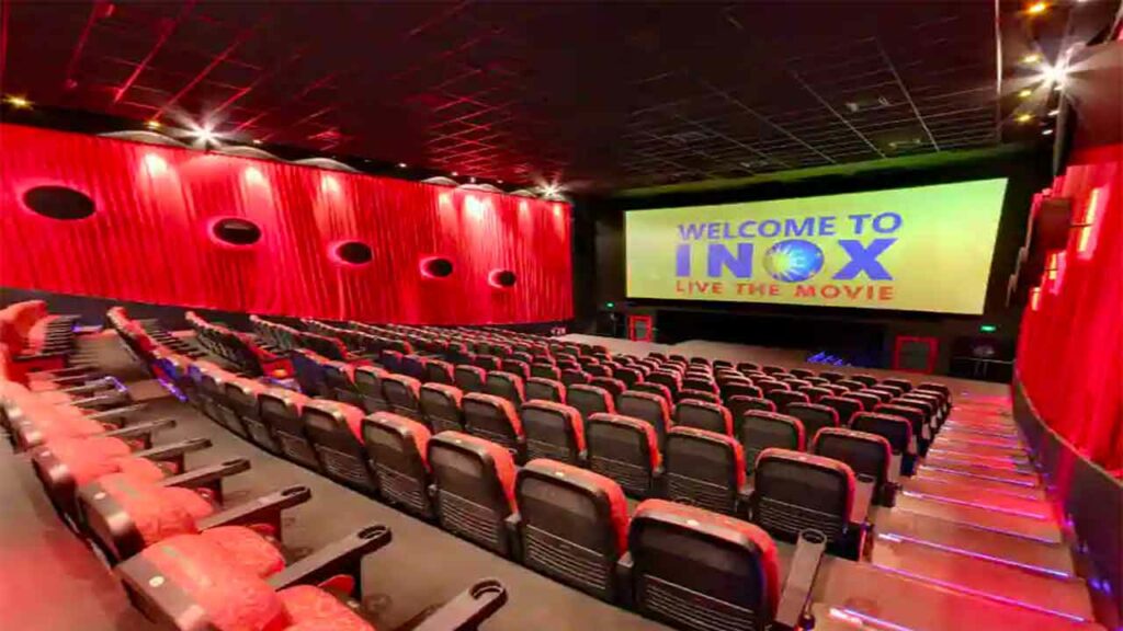 a cinema hall with red seatss