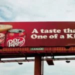 A cold drink advertisement on a billboard.
