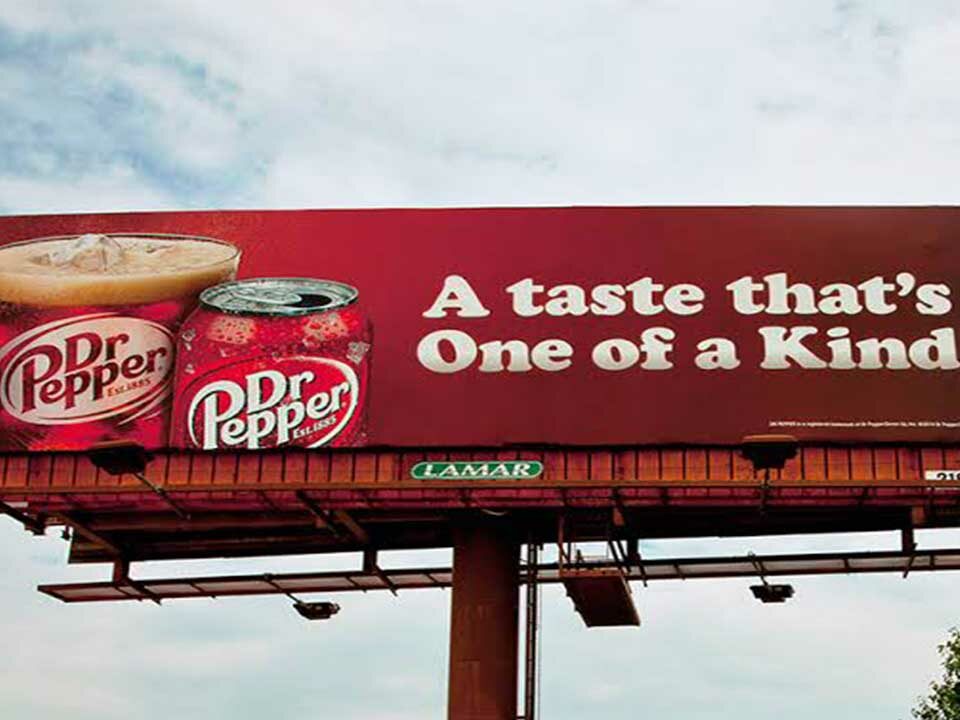 A cold drink advertisement on a billboard.