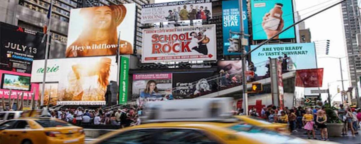 Numerous billboards being displayed on a busy street.
