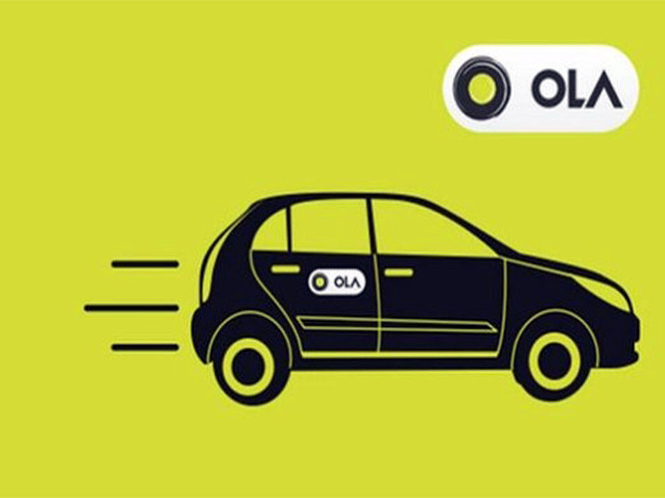 A cab with the Ola logo on a yellow backdrop