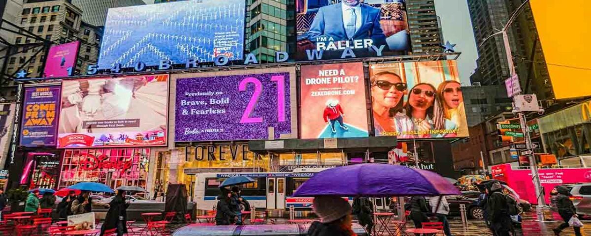 Creative and minimalistic billboards being displayed in a busy street.