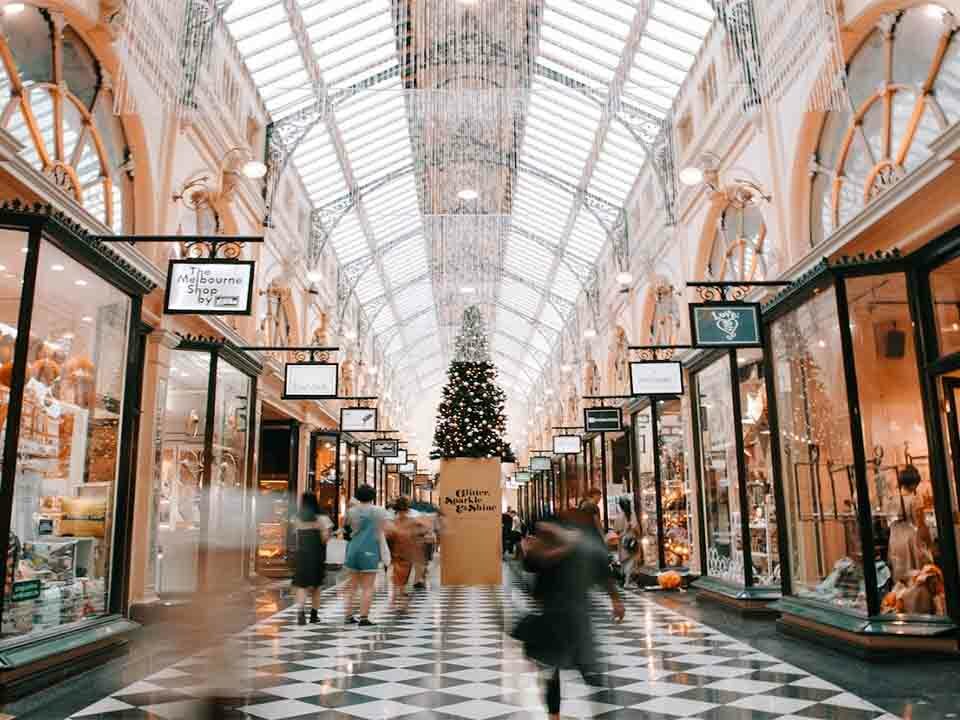 Display boards promoting various shops in the mall.