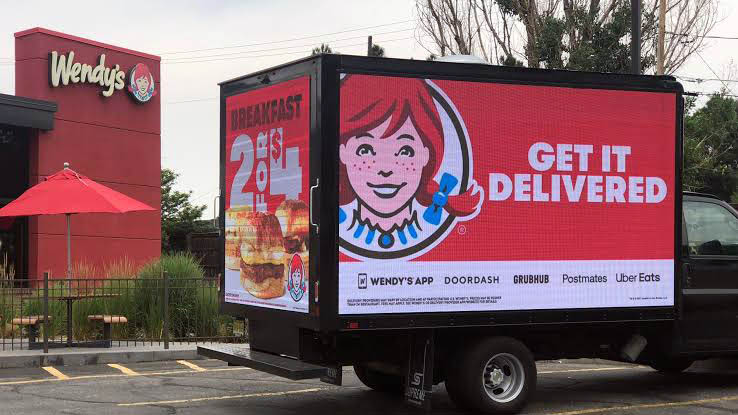 a advertisement of wendys's on a mobile truck.
