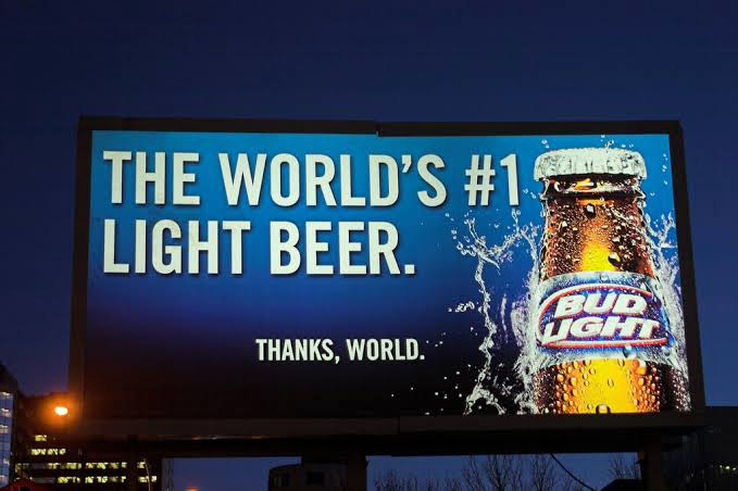 a backlit billboard advertising beer