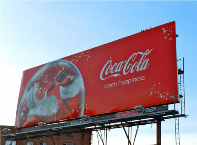 a static billboard of coca cola
