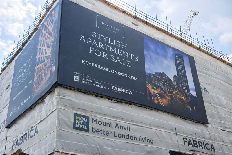 Large building wrap billboard advertising apartments for sale