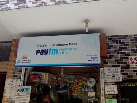 Local Shop Signage Advertising Paytm Payments Bank signage displayed outside a small neighborhood retail shop
