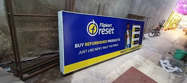 Flipkart Refurbished Outdoor Display Flipkart refurbished products advertisement on a roadside display board showing discounted electronics