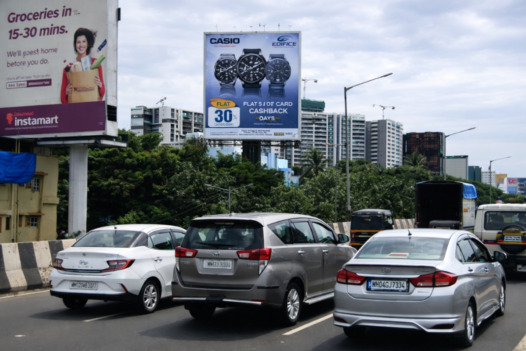 Casio Watch Billboard And Nearby Hoarding Above Traffic Casio Edifice watch billboard above traffic, with an Instamart advertisement on a nearby hoarding