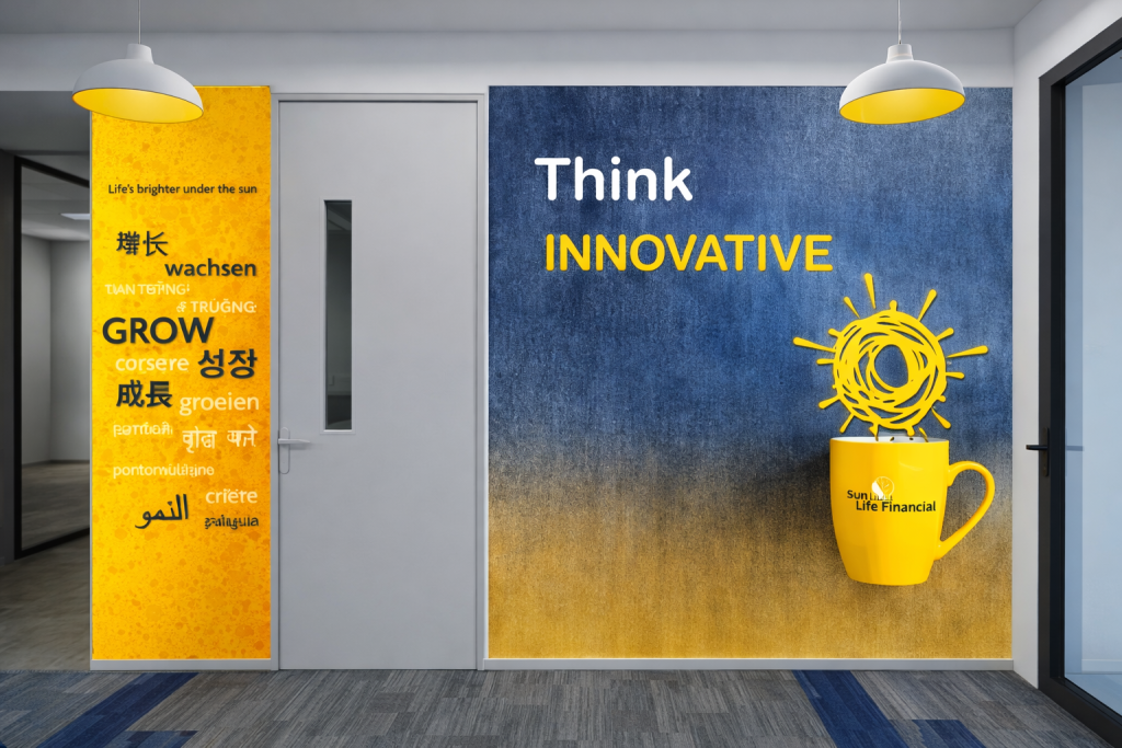 Sun Life Financial Office Wall Branding Corporate office interior featuring wall graphics reading “Think Innovative” alongside a large yellow mug illustration and multilingual growth-themed typography.