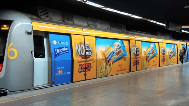 Sunfeast Farmlite Metro Train Advertising Wrap Metro train wrapped with Sunfeast Farmlite Digestive biscuit advertisements across multiple panels at a station platform.