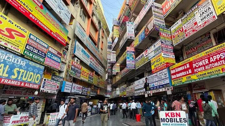 Busy marketplace street filled with numerous signboards and advertisements for coaching institutes and training centers. Busy marketplace street filled with numerous signboards and advertisements for coaching institutes and training centers.