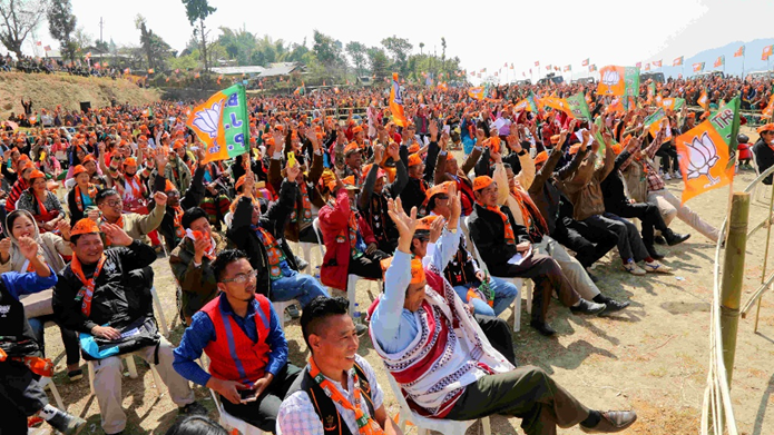 Massive BJP Election Rally with Supporters Waving Party Flags | Northeast India Political Campaign Large crowd of BJP supporters waving saffron party flags and lotus symbols at an outdoor election rally in Northeast India