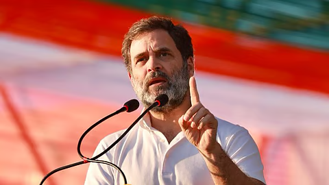 Indian Opposition Leader Addressing Election Rally | Congress Campaign Speech India Indian politician speaking at a public rally with microphones, raising one finger, against a red background