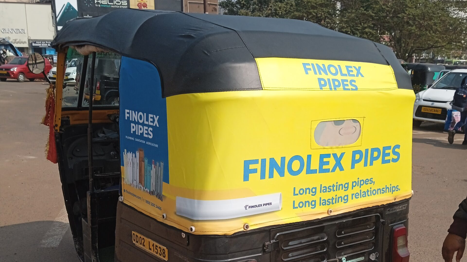 Finolex Pipes Auto Rickshaw Transit Advertising Auto rickshaw wrapped with Finolex Pipes branding promoting long-lasting pipes and relationships on a busy city road.