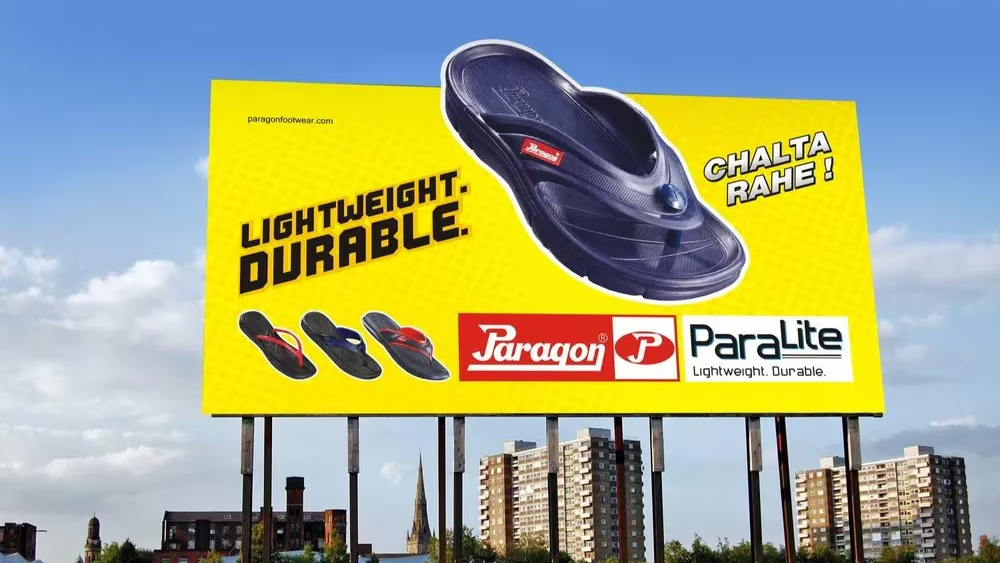 Paragon Paralite Footwear Outdoor Billboard Campaign Large roadside billboard promoting Paragon Paralite lightweight durable footwear with a bright yellow background and sandal display.