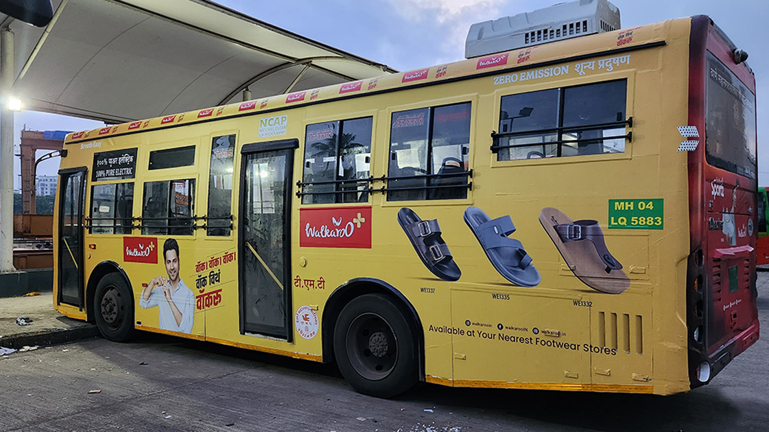 Walkaroo Footwear Bus Wrap Transit Advertising City bus wrapped with Walkaroo footwear advertisement displaying multiple sandal designs and brand messaging.