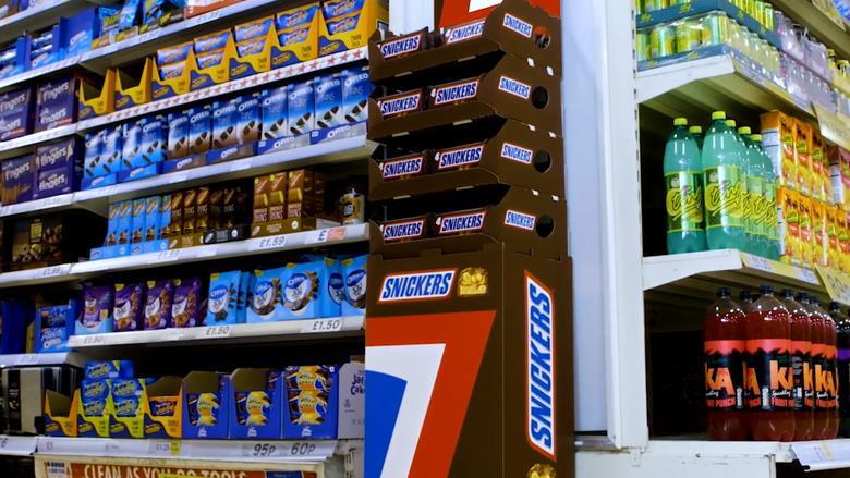 Snickers point of sale retail display advertising Snickers retail shelf display with branded product stand in supermarket environment