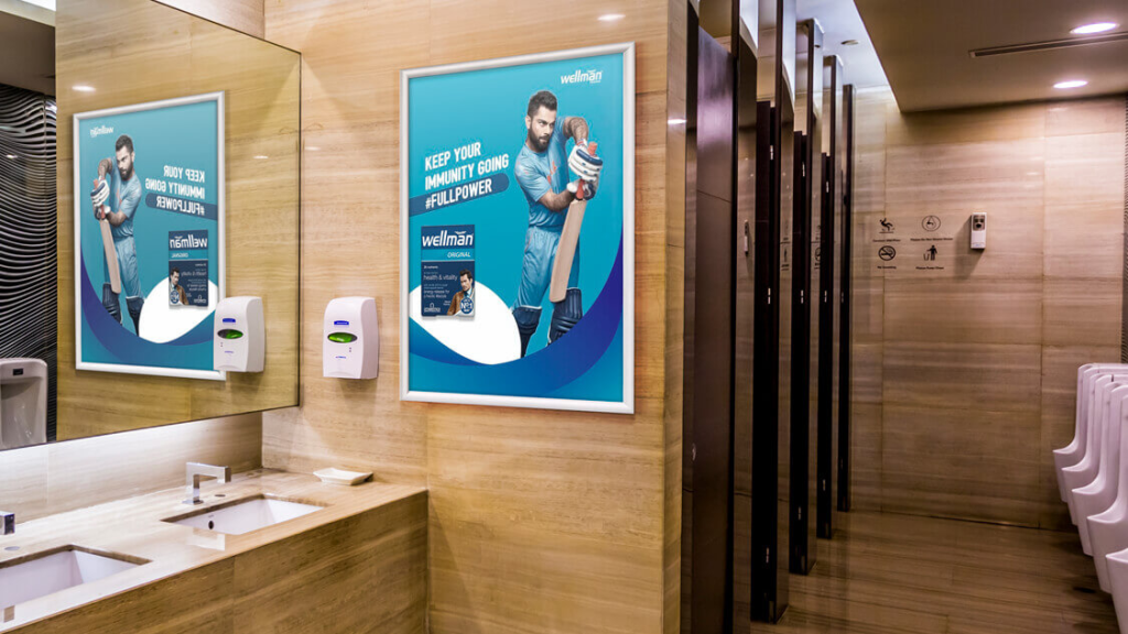 Washroom Advertising for Targeted Brand Recall restroom advertising poster inside mall washroom targeting captive audience attention