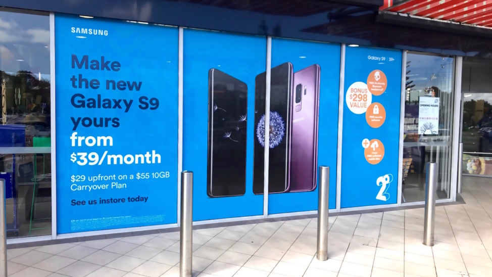 Storefront Glass Branding Campaign for Smartphone Promotion storefront glass advertising for Samsung Galaxy S9 promotion in retail shopping area